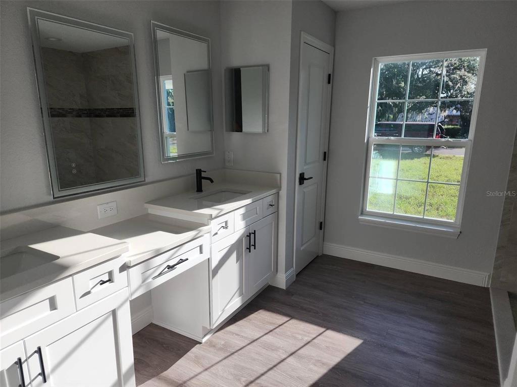 1111 Dagmar Avenue Spring Hill, FL 34606 - Photo 2 of 27 a kitchen with granite countertop a sink stove and cabinets