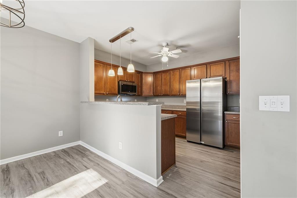 331 Oakview Way Canton, GA 30114 - Photo 12 of 42 a kitchen with stainless steel appliances granite countertop a refrigerator a sink and a stove with wooden floor
