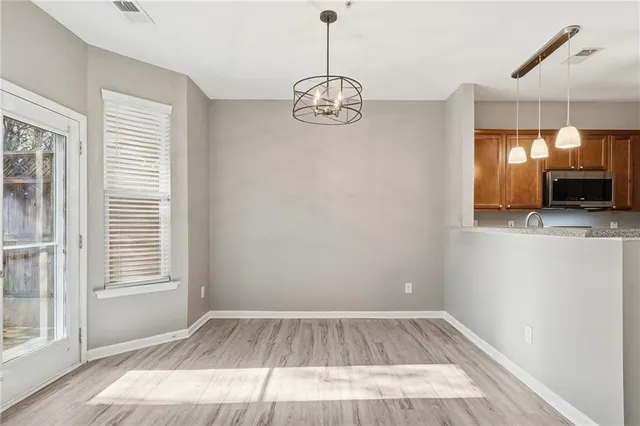 a view of a room with wooden floor and windows
