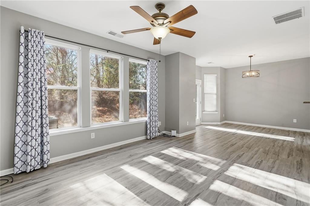 331 Oakview Way Canton, GA 30114 - Photo 16 of 42 a view of an empty room with a window and a ceiling fan