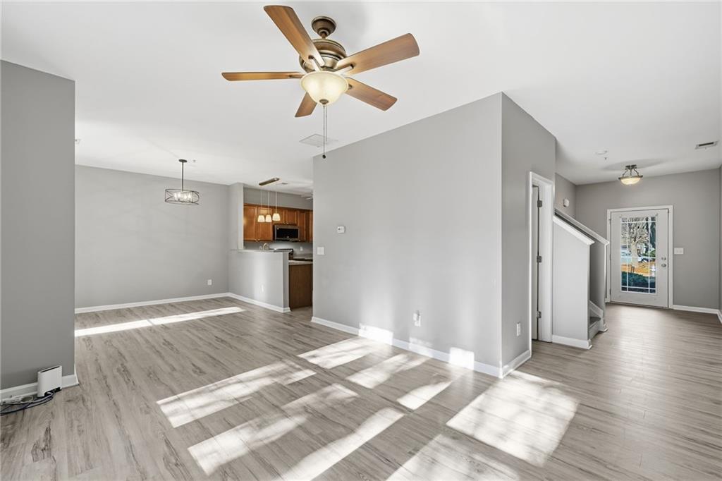 331 Oakview Way Canton, GA 30114 - Photo 18 of 42 a view of a livingroom with wooden floor and a ceiling fan