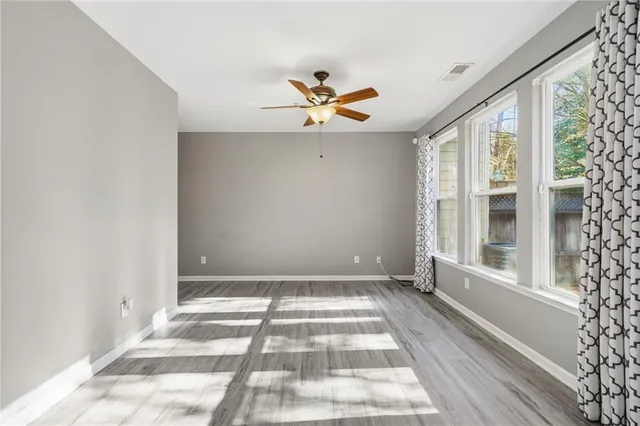 wooden floor in an empty room with a window