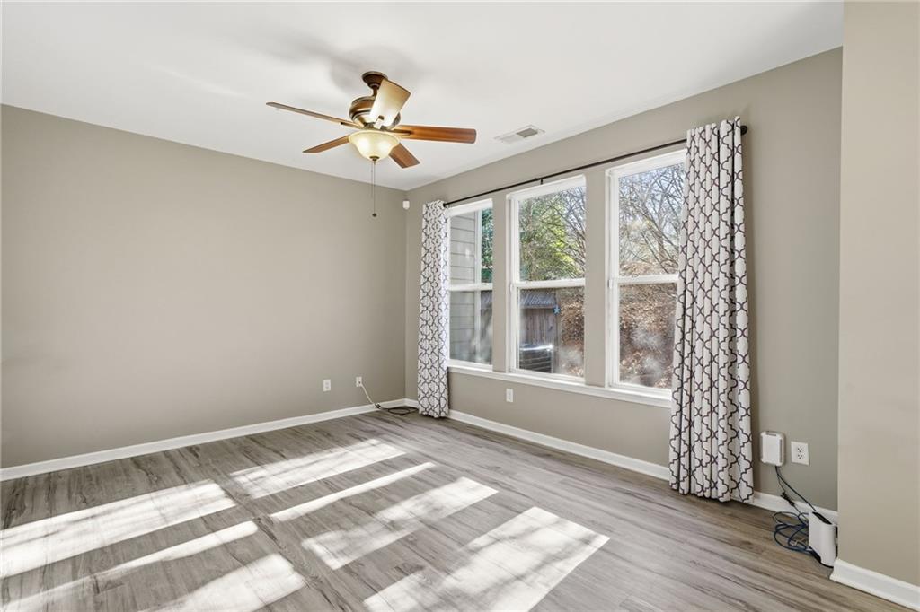 331 Oakview Way Canton, GA 30114 - Photo 20 of 42 a view of an empty room with a window and wooden floor