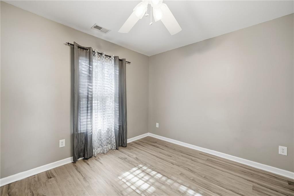 331 Oakview Way Canton, GA 30114 - Photo 24 of 42 an empty room with wooden floor and windows