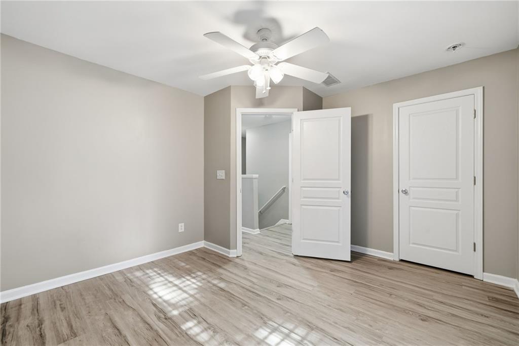 331 Oakview Way Canton, GA 30114 - Photo 25 of 42 an empty room with wooden floor and ceiling fan