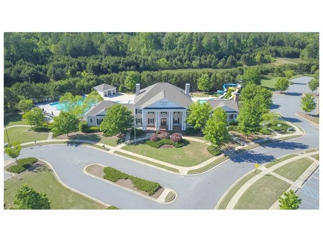 a swimming pool with outdoor seating and yard