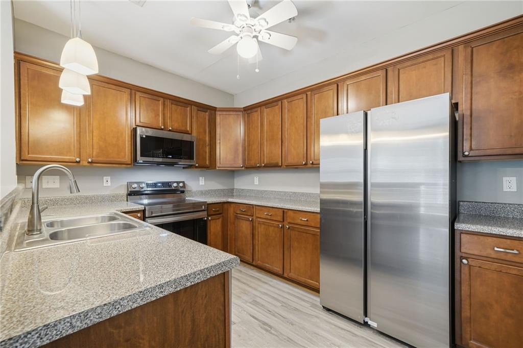 331 Oakview Way Canton, GA 30114 - Photo 10 of 42 a kitchen with stainless steel appliances granite countertop a refrigerator a stove top oven a sink and dishwasher