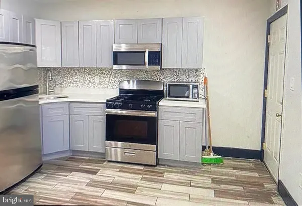 a kitchen with a stove and a cabinets