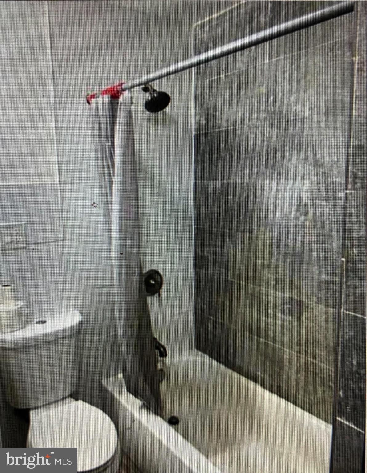 4754 Alhambra Avenue Baltimore, MD 21212 - Photo 4 of 10 a bathroom with a toilet and a shower