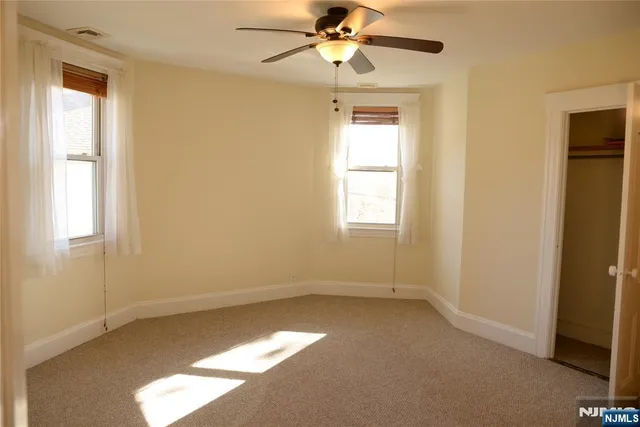 a white bath tub sitting next to a white toilet and a shower