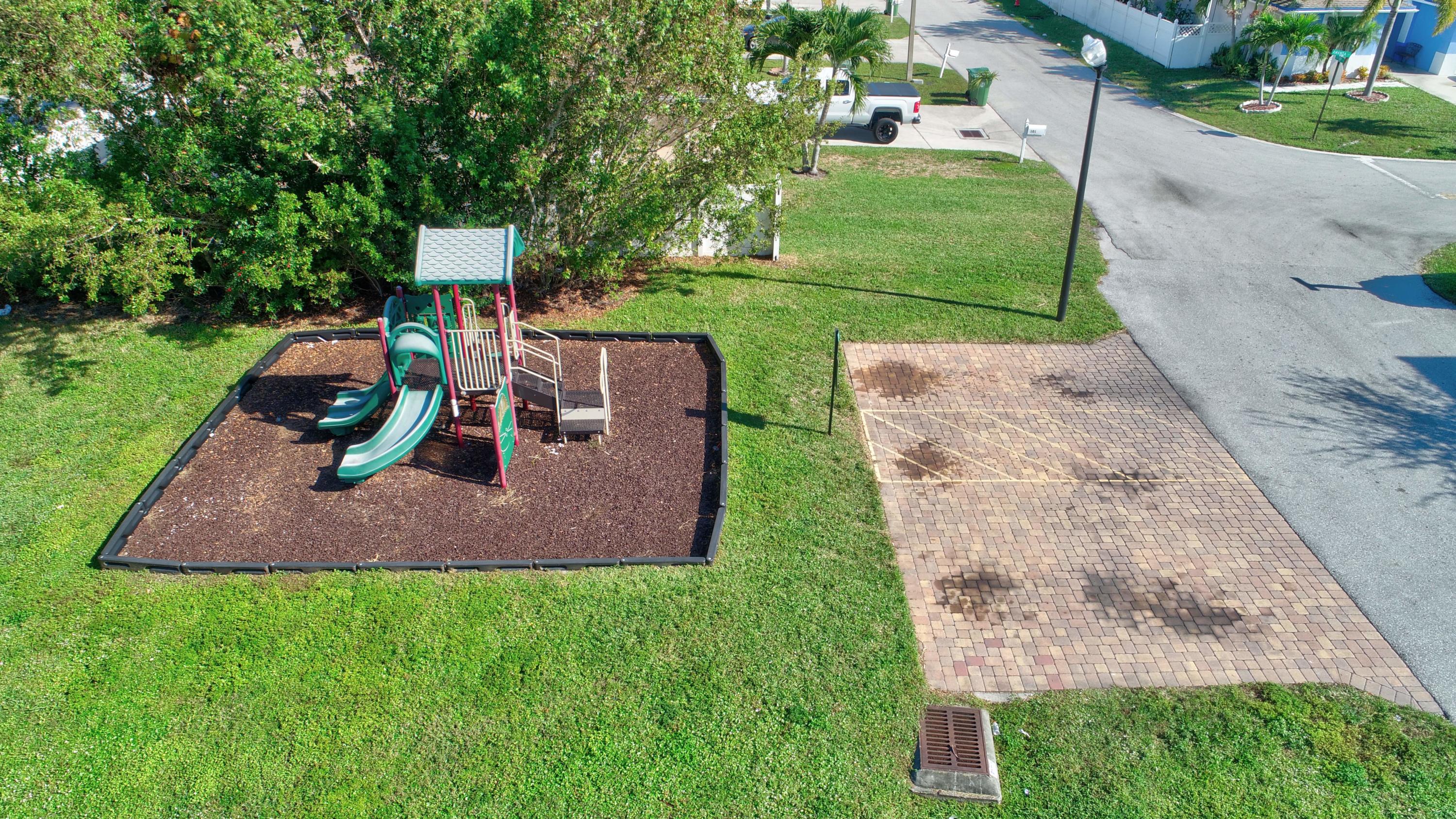 116 Williams Court Palm Springs, FL 33461 - Photo 16 of 17 a view of a garden with plants and a park