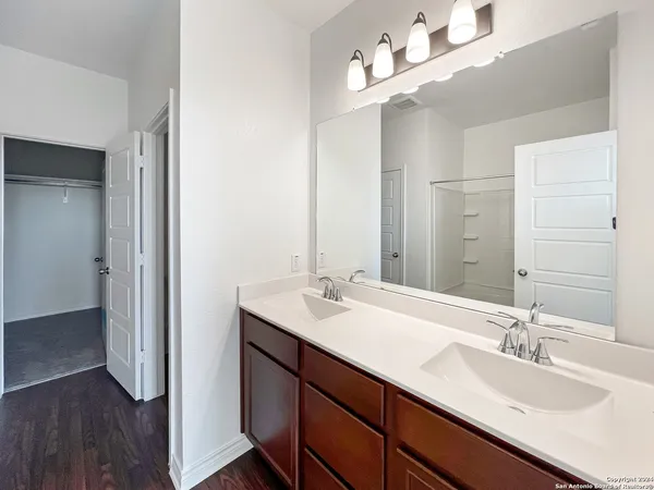a bathroom with a sink double vanity and a mirror