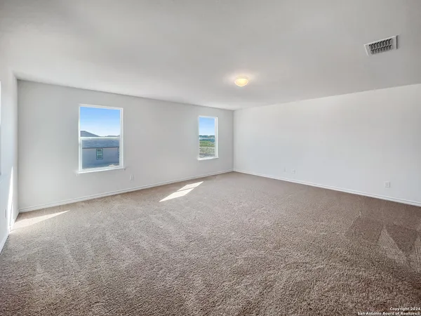 an empty room with windows and closet