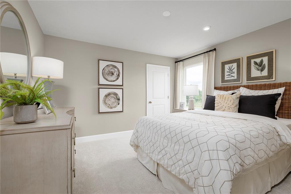 436 Elm Spg Road St. Cloud, FL 34771 - Photo 11 of 14 a bedroom with a bed and a potted plant