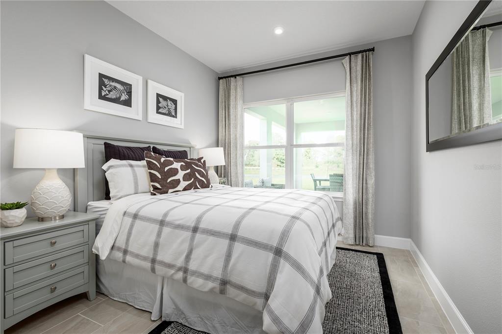 436 Elm Spg Road St. Cloud, FL 34771 - Photo 9 of 14 a bedroom with a large bed and a window