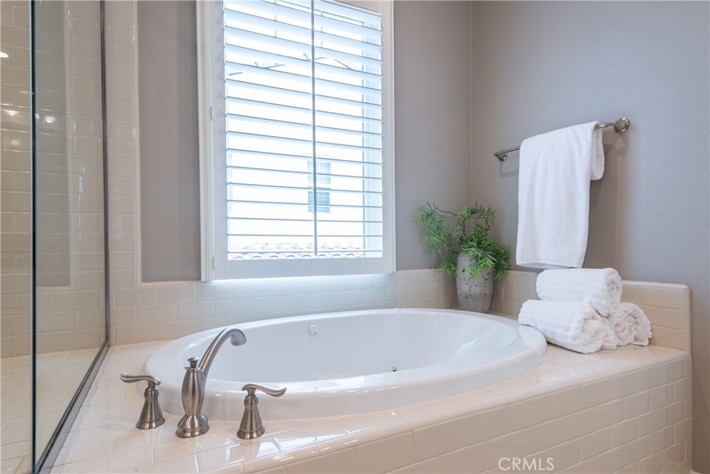 120 Mongoose Irvine, CA 92618 - Photo 12 of 42 a white bath tub sitting in a bathroom next to a window