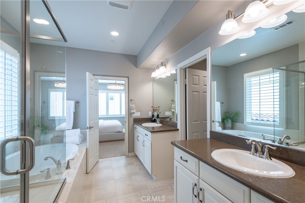 120 Mongoose Irvine, CA 92618 - Photo 15 of 42 a spacious bathroom with a granite countertop sink a toilet a mirror and shower