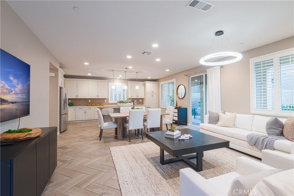 120 Mongoose Irvine, CA 92618 - Photo 40 of 42 a living room with furniture a rug and a kitchen view