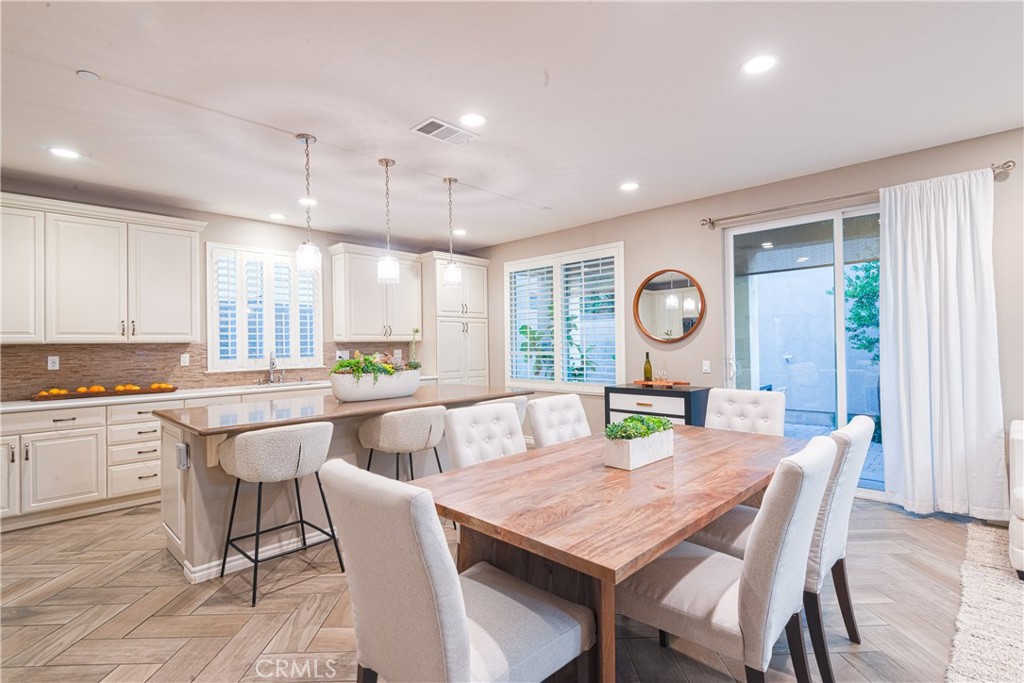 120 Mongoose Irvine, CA 92618 - Photo 20 of 42 a view of a dining room and livingroom with furniture wooden floor and a window