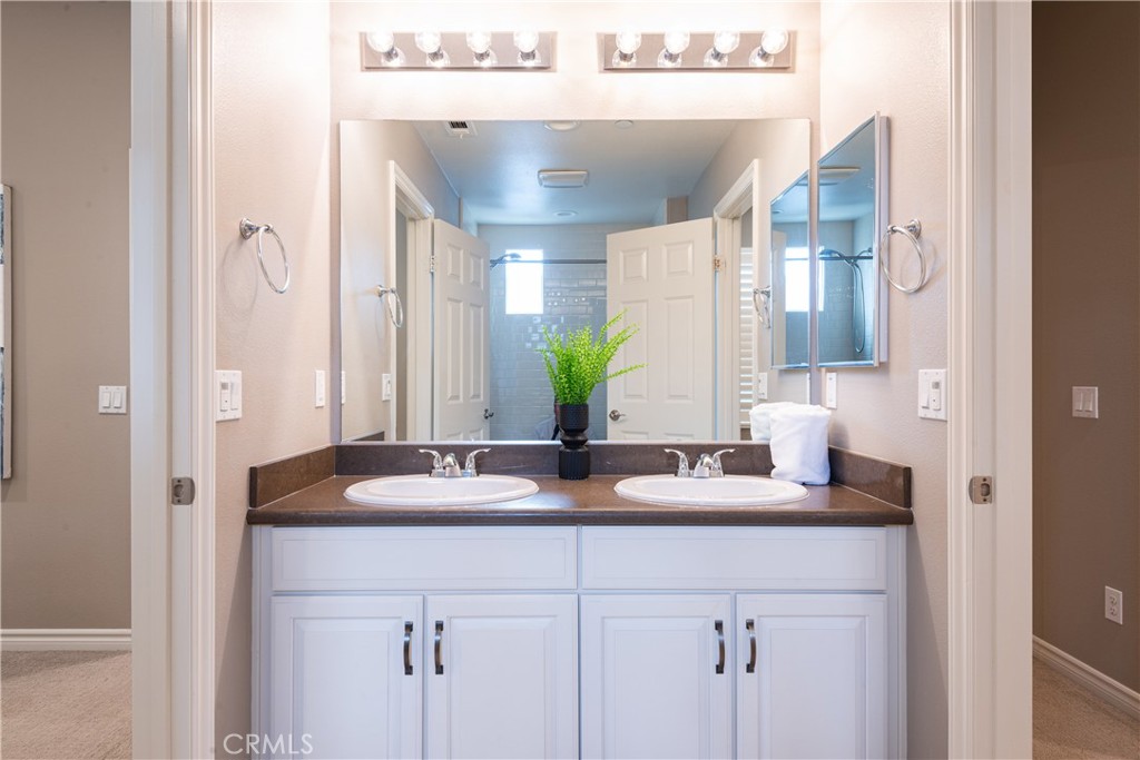 120 Mongoose Irvine, CA 92618 - Photo 27 of 42 a bathroom with a double vanity sink and a mirror
