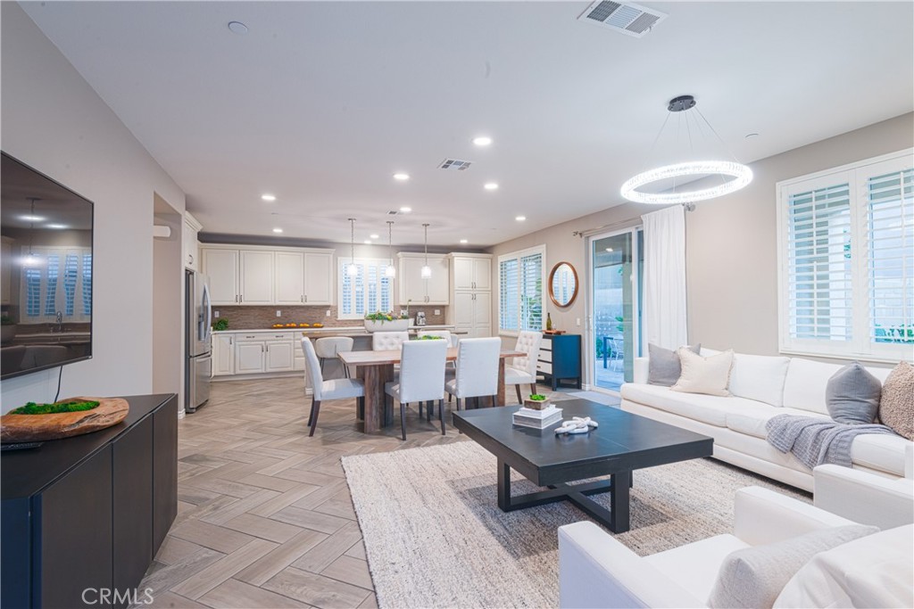 120 Mongoose Irvine, CA 92618 - Photo 38 of 42 a living room with furniture a rug and a kitchen view