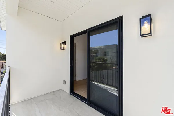 a view of balcony with wooden floor and fence