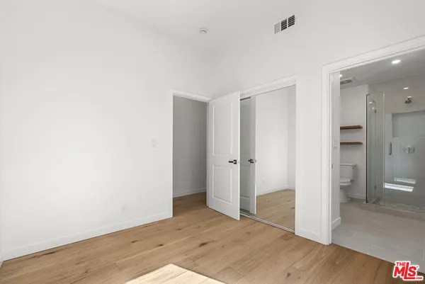 a bathroom with a toilet a sink and shower