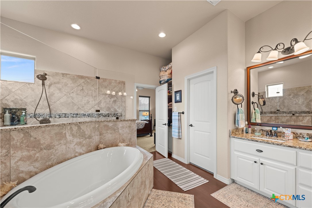 2649 Bowles Ranch Road Belton, TX 76513 - Photo 16 of 36 a bathroom with a bathtub a mirror and a shower