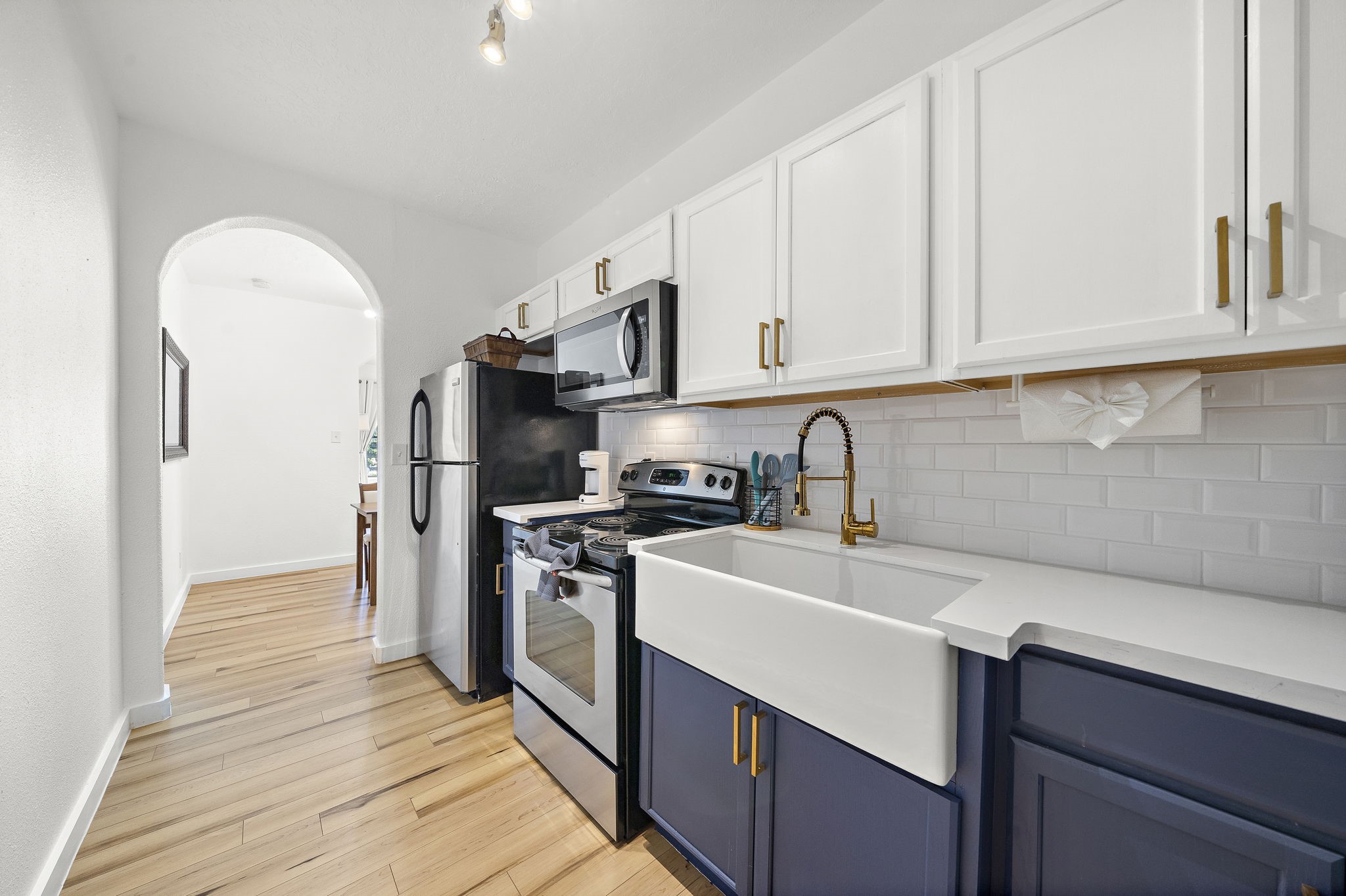 3901 Dallas Street, Unit D Houston, TX 77023 - Photo 15 of 35 a kitchen with stainless steel appliances granite countertop a sink stove and refrigerator