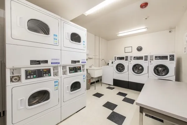a utility room with dryer washer and sink