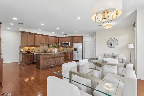 a living room with kitchen island furniture and a chandelier