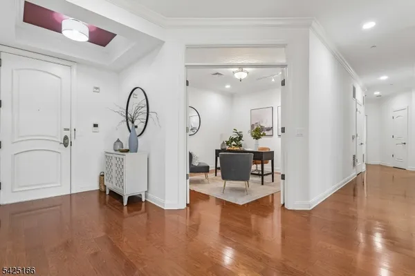 a view of a livingroom with furniture a fireplace wooden floor and windows