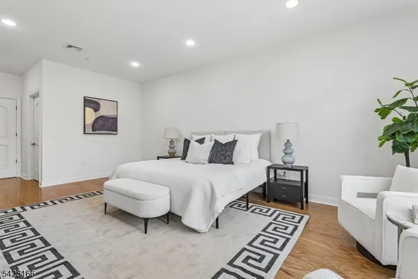 a spacious bedroom with a bed and a couch