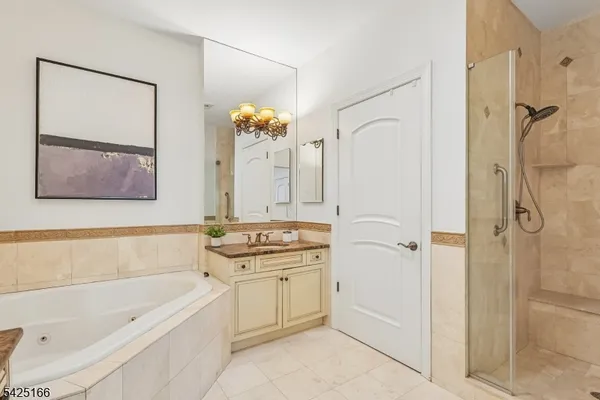 a bathroom with a tub sink and mirror