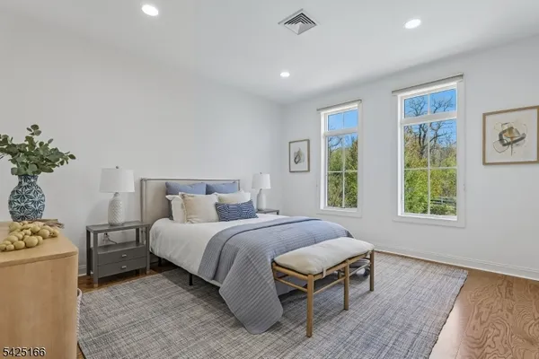 a spacious bedroom with a bed and a window