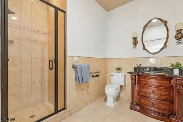 a bathroom with a toilet and a mirror
