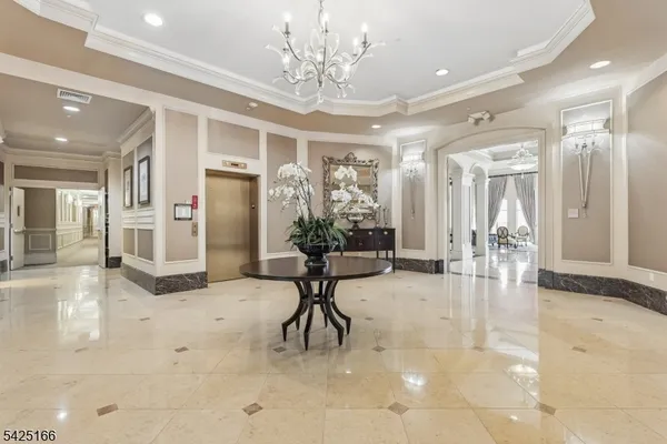 a view of a lobby with furniture and a chandelier