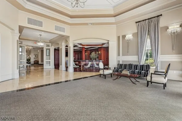 a view of a livingroom with furniture and a large window