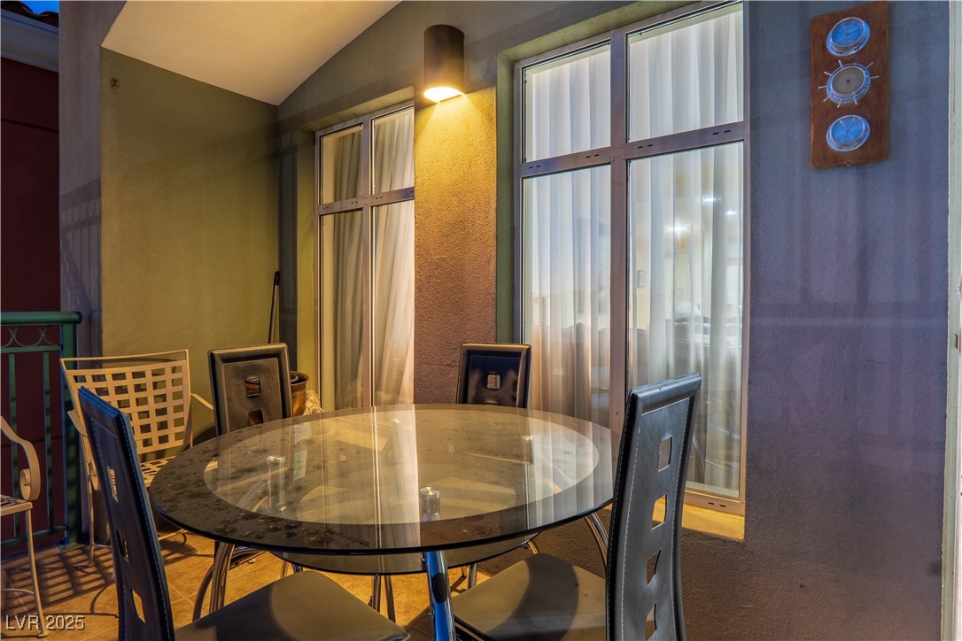 30 Strada Di Villaggio, Unit 617 Henderson, NV 89011 - Photo 31 of 34 Dining area featuring lofted ceiling and a textured wall