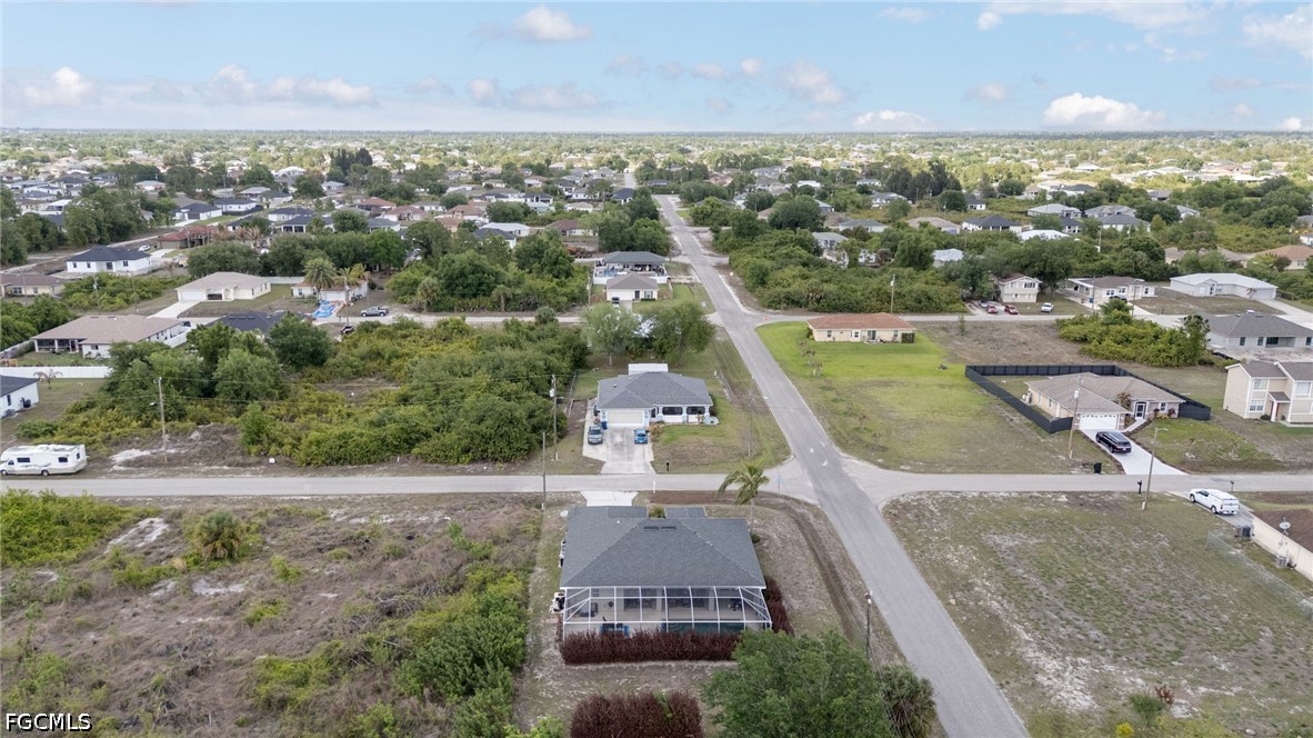 3801 28th Street Southwest Lehigh Acres, FL 33976 - Photo 33 of 37 an aerial view of a house with a garden and lake view