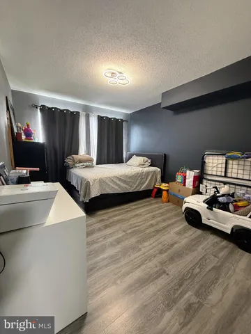 a living room with two bed furniture and a flat screen tv