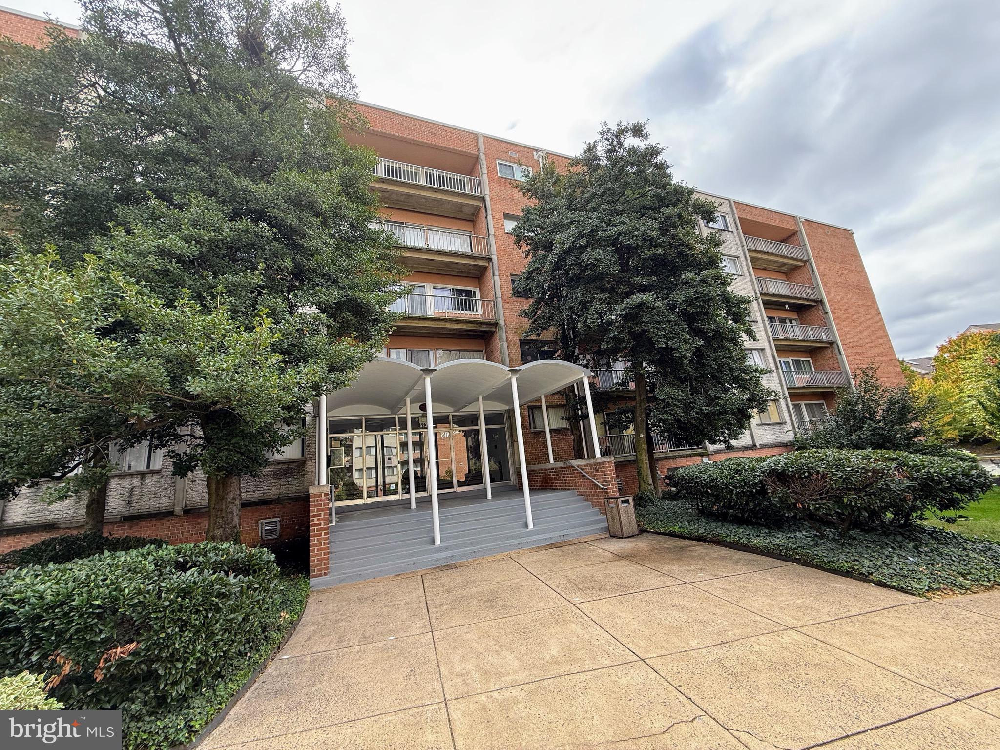 5831 Quantrell Avenue, Unit 505 Alexandria, VA 22312 - Photo 22 of 22 a view of a patio with table and chairs and potted plants
