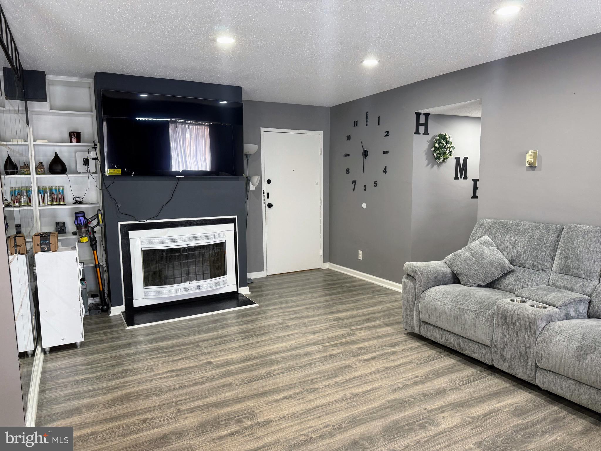 5831 Quantrell Avenue, Unit 505 Alexandria, VA 22312 - Photo 4 of 22 a living room with furniture and a fireplace