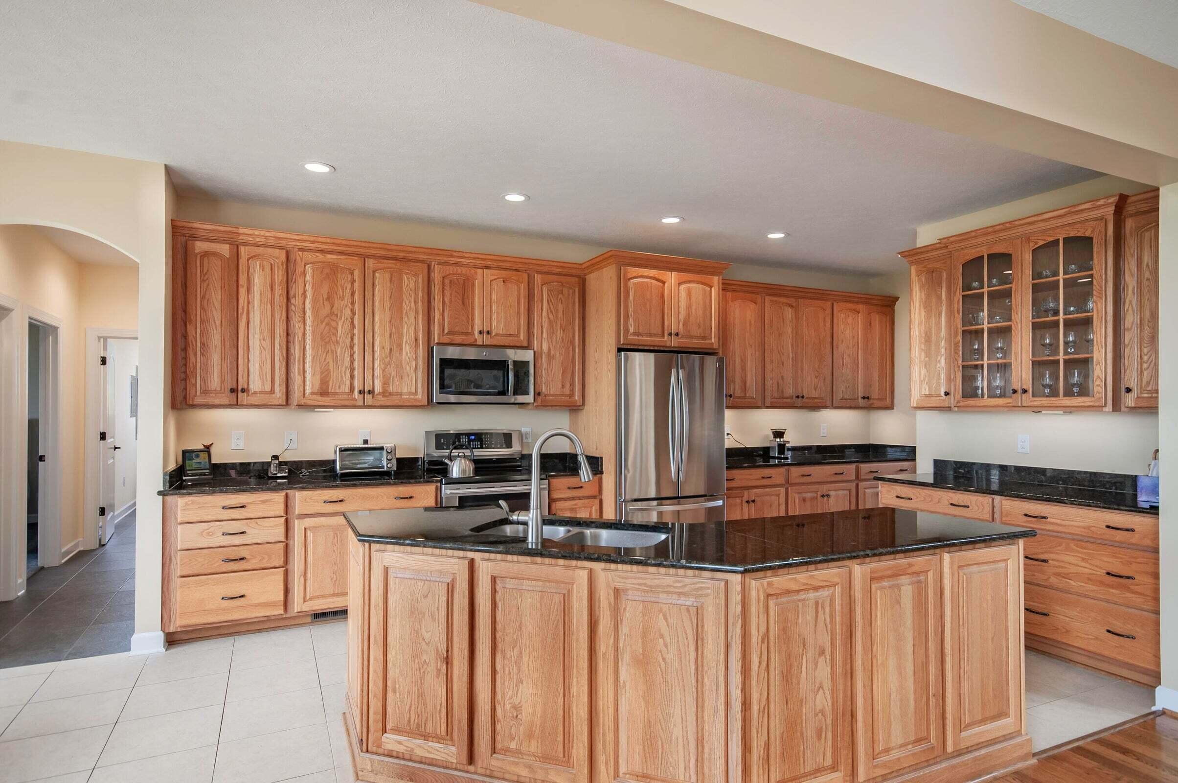 1875 Ridge Road Raphine, VA 24472 - Photo 22 of 72 a kitchen with stainless steel appliances granite countertop a stove top oven a sink dishwasher and a refrigerator with wooden cabinets