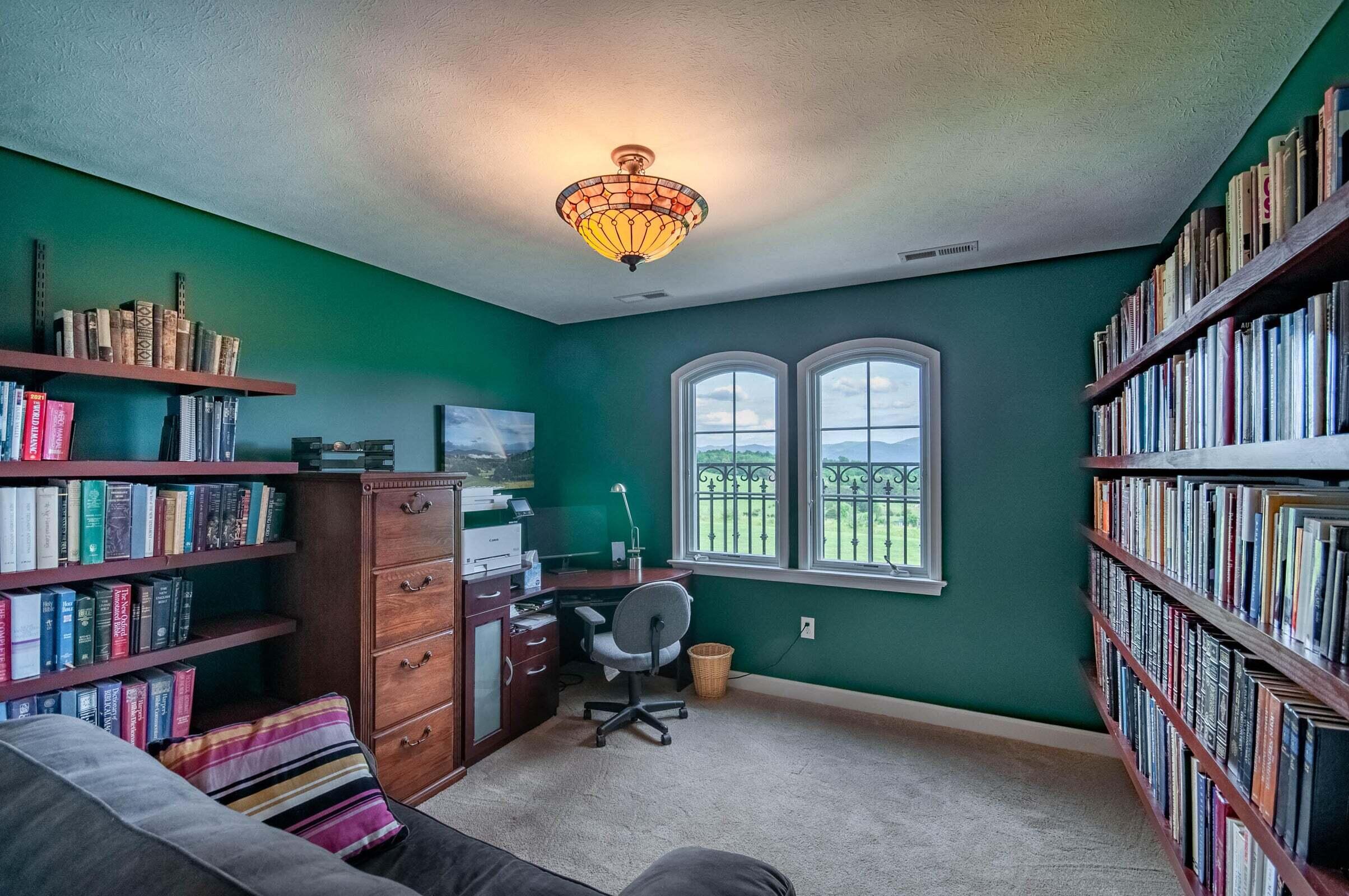 1875 Ridge Road Raphine, VA 24472 - Photo 54 of 72 a livingroom with bookshelf and a workspace