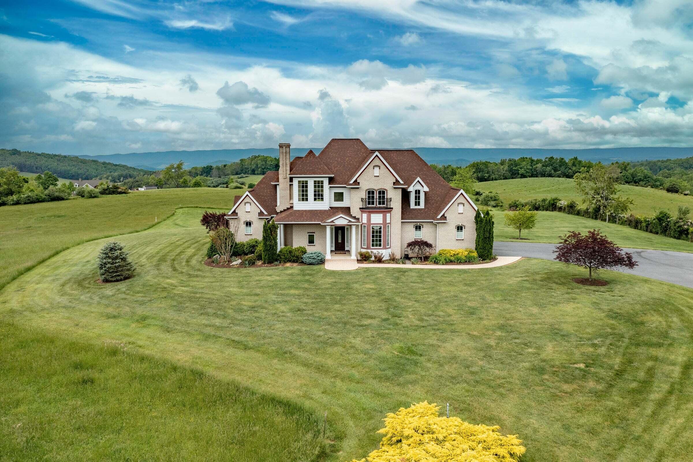 1875 Ridge Road Raphine, VA 24472 - Photo 67 of 72 a view of a white house with a big yard and large trees