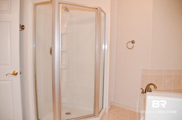 5751 Alabama Street Orange Beach, AL 36561 - Photo 18 of 25 The Master Bath features a Jacuzzi tub and double vanity plus a separate shower.