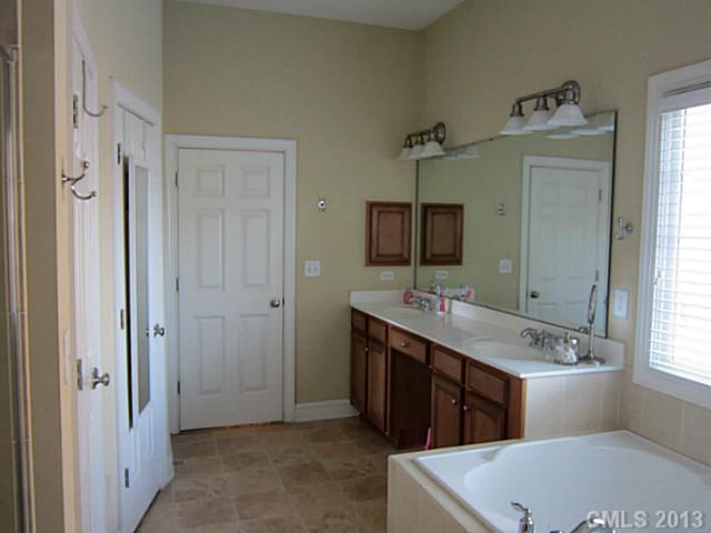435 Third Baxter Street Fort Mill, SC 29708 - Photo 3 of 12 a bathroom with a tub sink and mirror