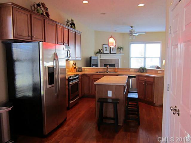 435 Third Baxter Street Fort Mill, SC 29708 - Photo 4 of 12 a kitchen with stainless steel appliances a refrigerator a sink dishwasher a dining table and chairs with wooden floor