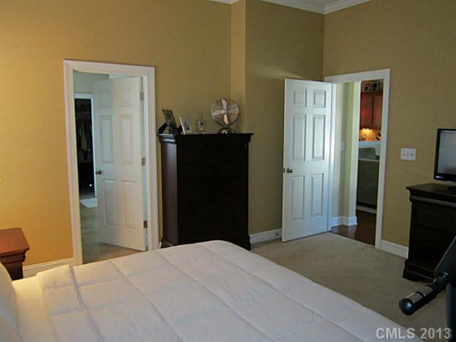 435 Third Baxter Street Fort Mill, SC 29708 - Photo 9 of 12 a bedroom with a bed and a flat tv screen on a dresser